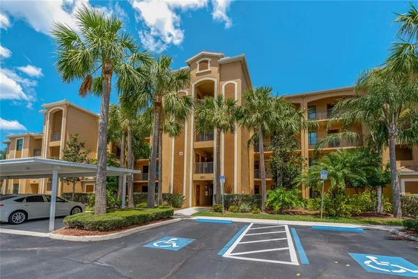 an aerial view of a house with a garden and lake view