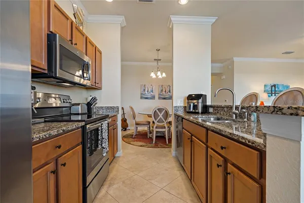 a bedroom with a bed and a lamp on a dresser