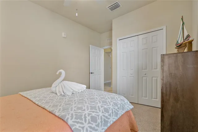 a bathroom with a toilet a sink a mirror and vanity