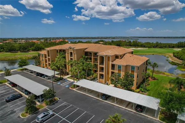 a roof deck with a couches and potted plants with sky view