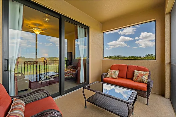 a front view of a house with a garden and lake view