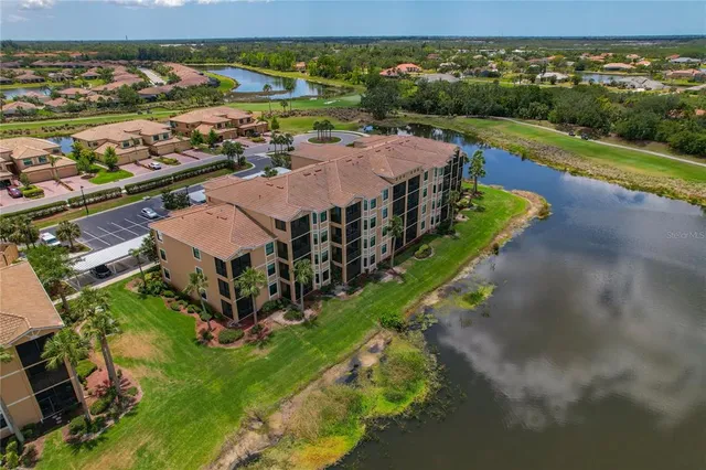 a view of a dining room with furniture and a swimming pool
