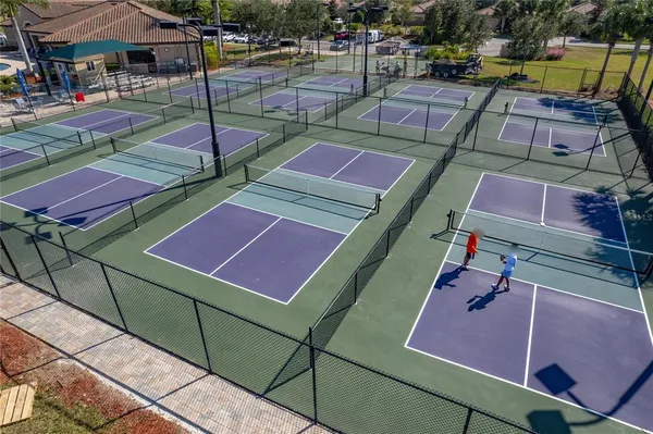a kitchen with a refrigerator and a dining table