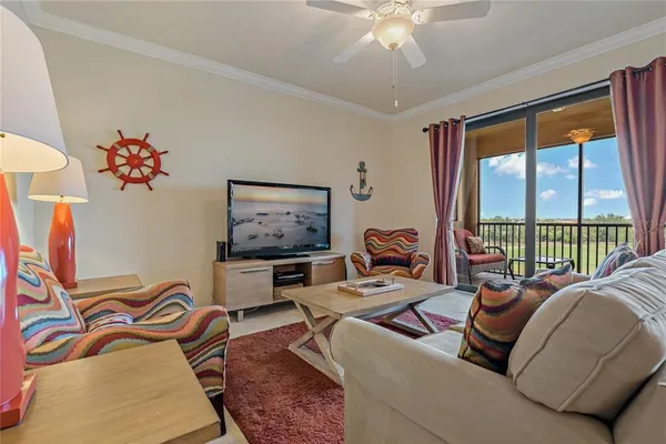 a living room with furniture and a chandelier