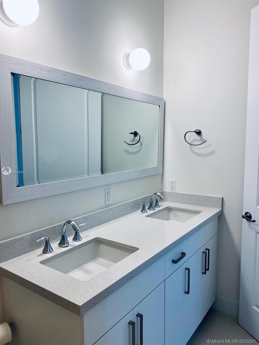 3318 Day Avenue, Unit 2 Miami, FL 33133 - Photo 12 of 29 a bathroom with a sink and a mirror