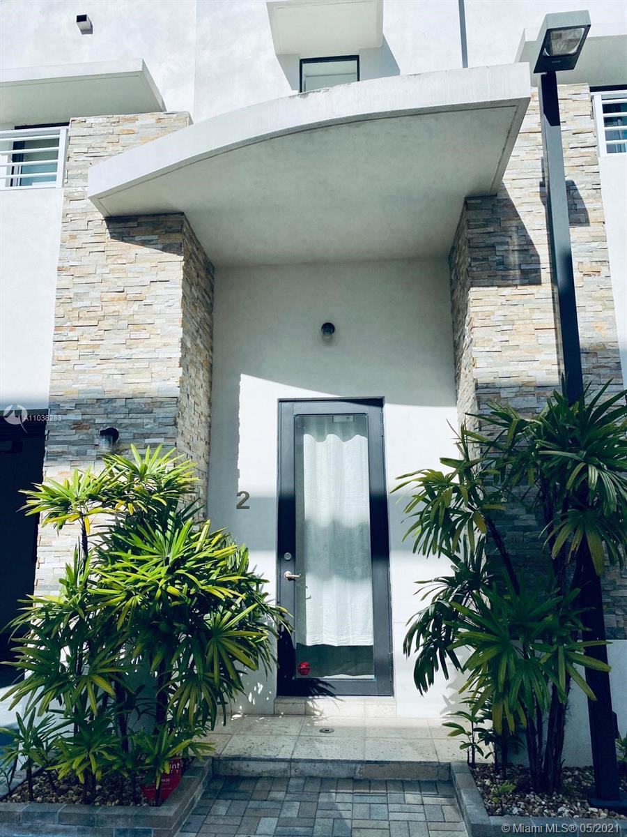 3318 Day Avenue, Unit 2 Miami, FL 33133 - Photo 5 of 29 a potted plant sitting in front of a house