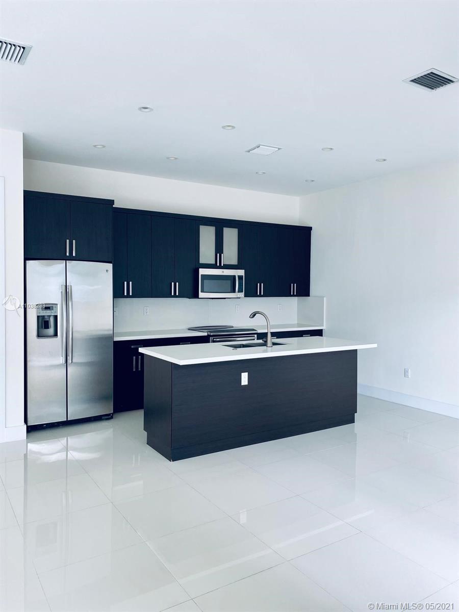 3318 Day Avenue, Unit 2 Miami, FL 33133 - Photo 7 of 29 a kitchen with stainless steel appliances a large counter top
