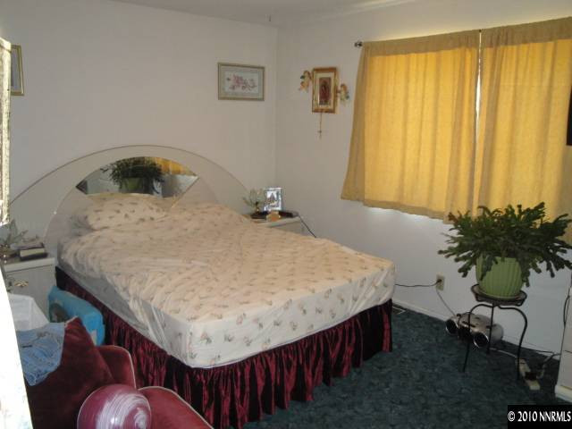 3320 Kings Row Reno, NV 89503 - Photo 5 of 9 a bed sitting in a bedroom next to a window