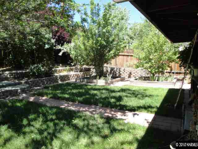 3320 Kings Row Reno, NV 89503 - Photo 9 of 9 a view of backyard with table and chairs and wooden fence