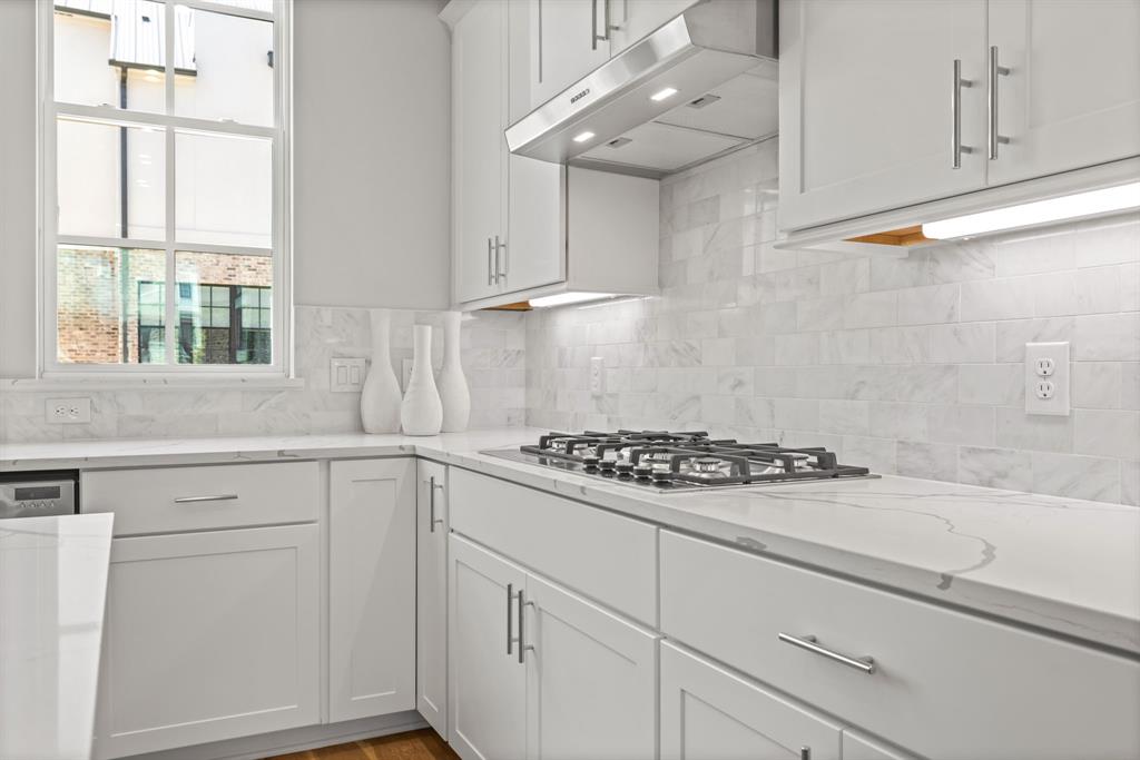 5461 Patterson Court Irving, TX 75039 - Photo 11 of 40 a kitchen with white cabinets and appliances