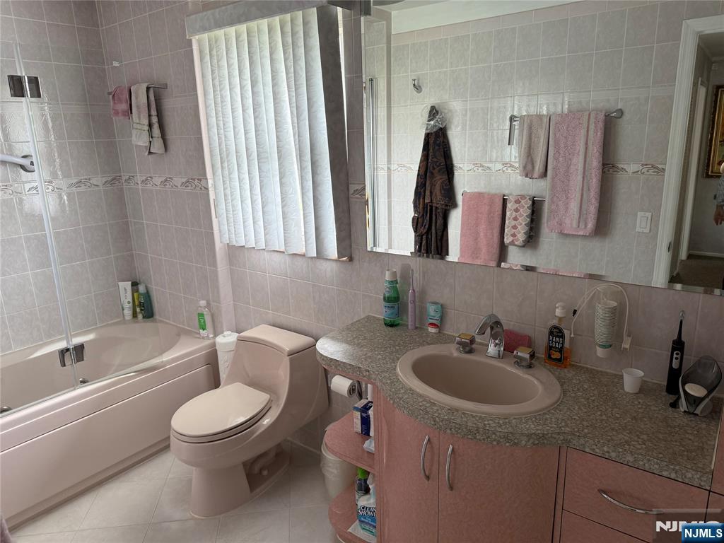 21 A Millar Court Paramus, NJ 07652 - Photo 11 of 24 a bathroom with a toilet sink and mirror