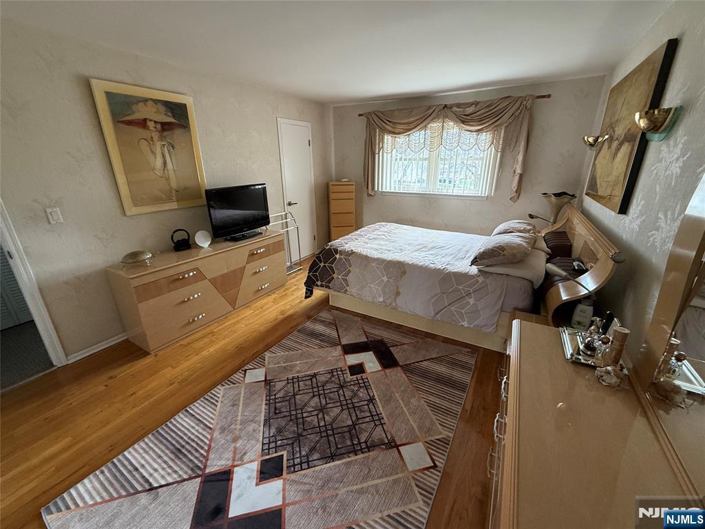 21 A Millar Court Paramus, NJ 07652 - Photo 13 of 24 a bedroom with furniture and a flat screen tv