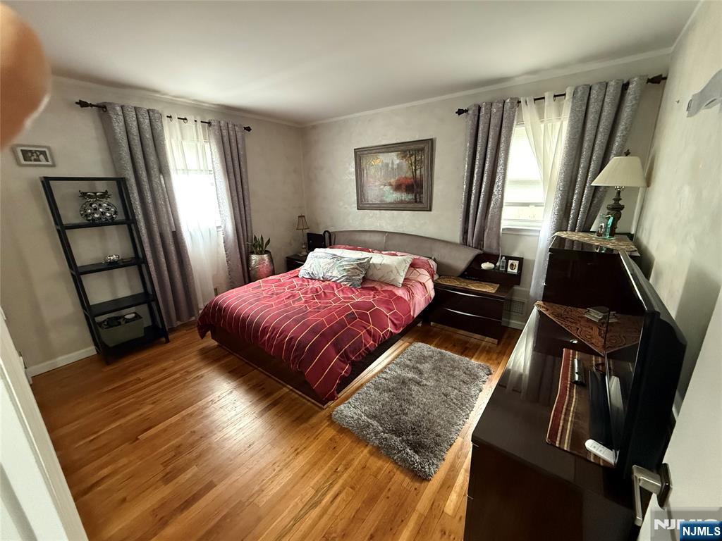 21 A Millar Court Paramus, NJ 07652 - Photo 14 of 24 a bedroom with a bed and a flat tv screen on the dresser