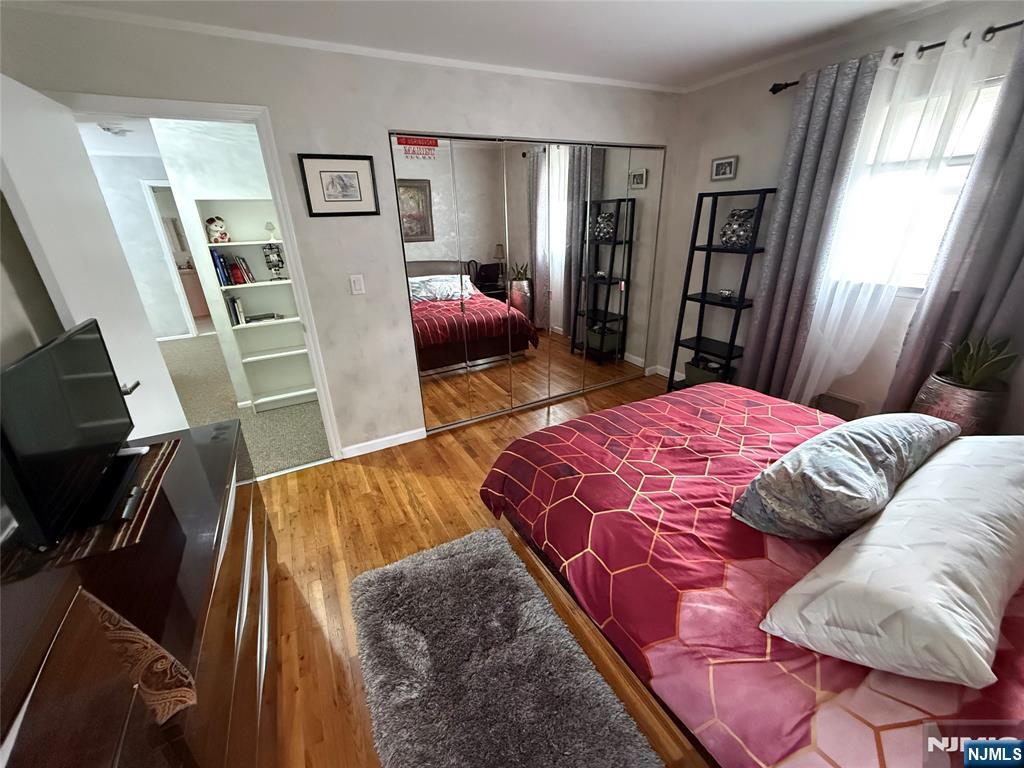 21 A Millar Court Paramus, NJ 07652 - Photo 15 of 24 a bedroom with a bed and wooden floor
