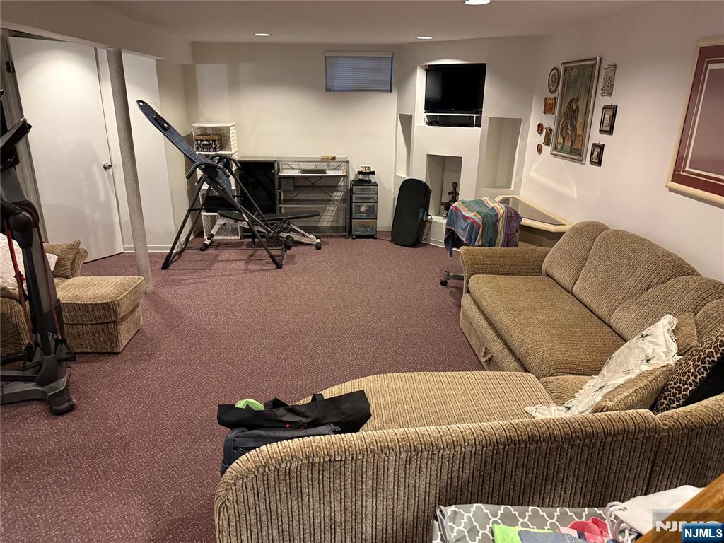 21 A Millar Court Paramus, NJ 07652 - Photo 18 of 24 a living room with furniture and a flat screen tv