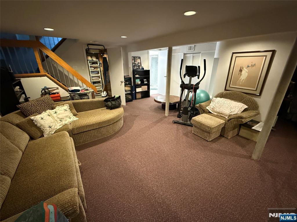 21 A Millar Court Paramus, NJ 07652 - Photo 20 of 24 a living room with furniture and a flat screen tv