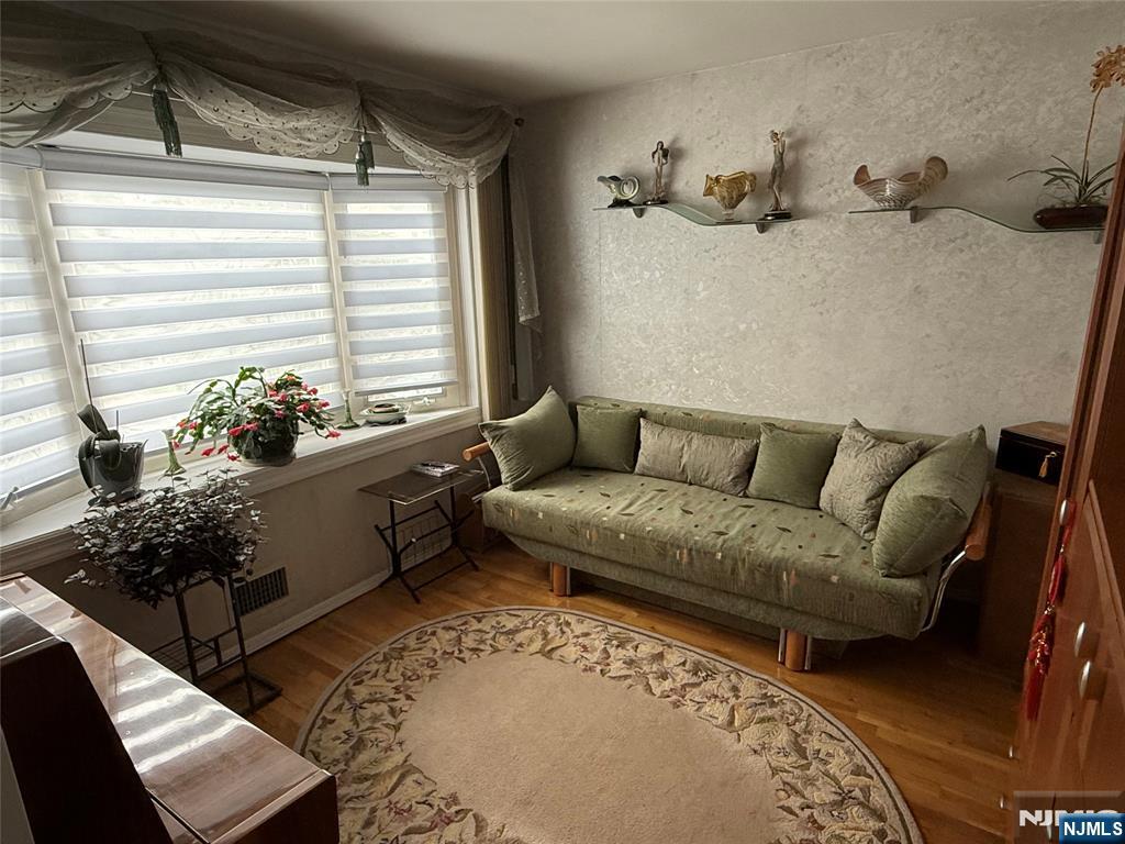 21 A Millar Court Paramus, NJ 07652 - Photo 8 of 24 a living room with furniture and a potted plant