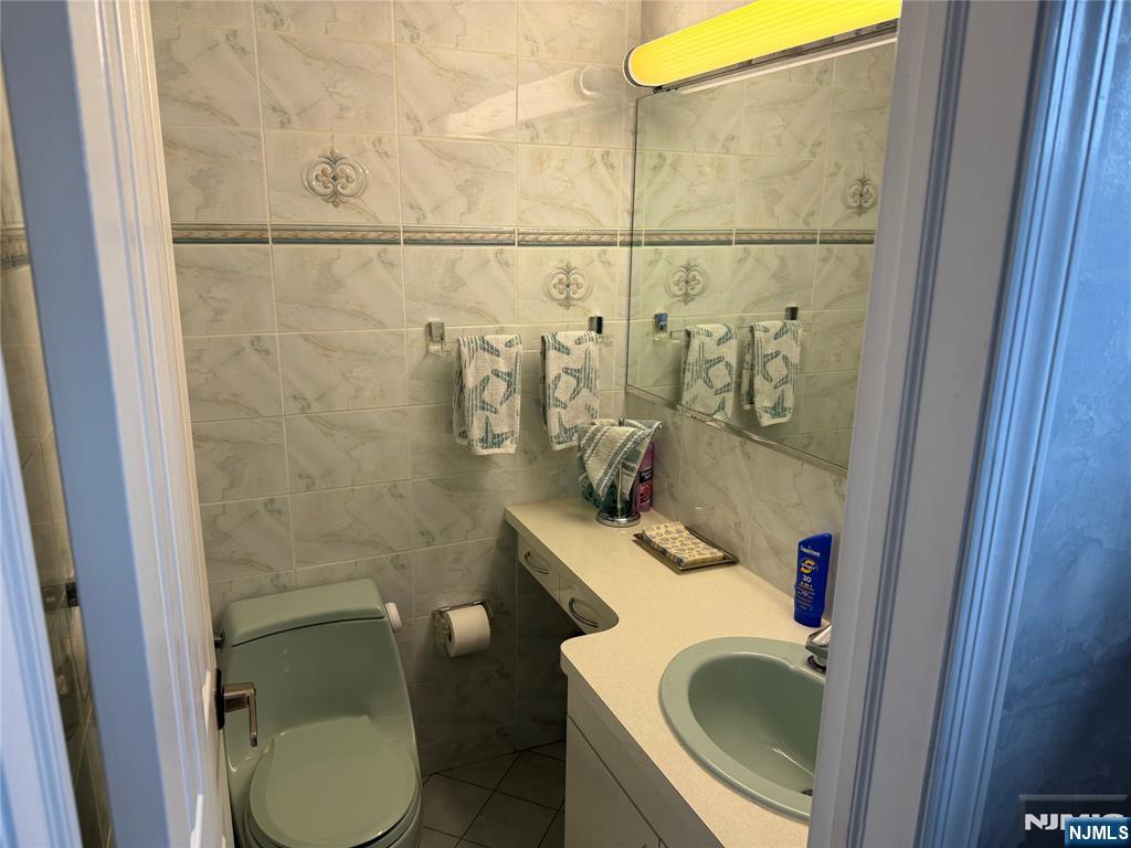 21 A Millar Court Paramus, NJ 07652 - Photo 10 of 24 a bathroom with a toilet and a sink