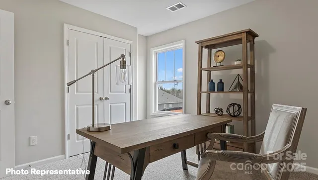 a view of a room that has a table and chairs in it