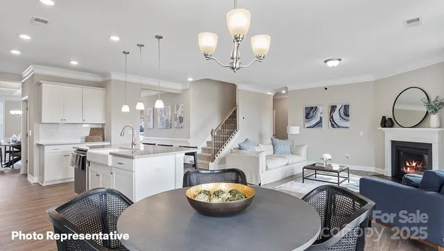 a living room with furniture a fireplace and kitchen view