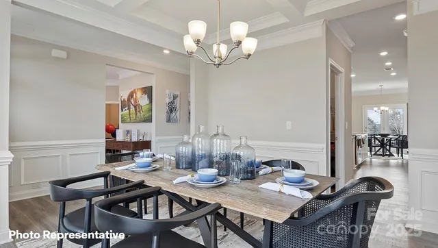 a view of a dining room with furniture and chandelier