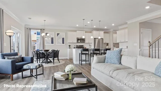a living room with furniture and kitchen view