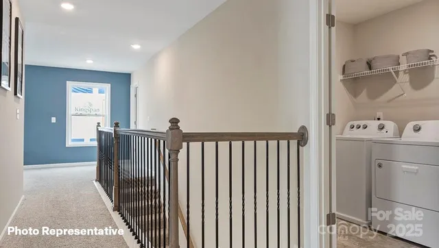 a view of a hallway with a dining table & a window