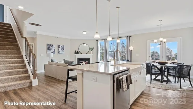 a living room with furniture a dining table and chairs