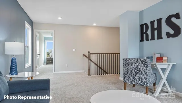 a living room with furniture and a lamp