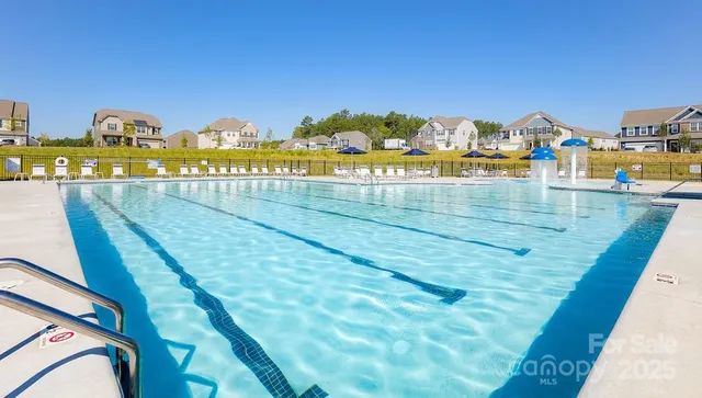 a view of swimming pool with a lawn chairs