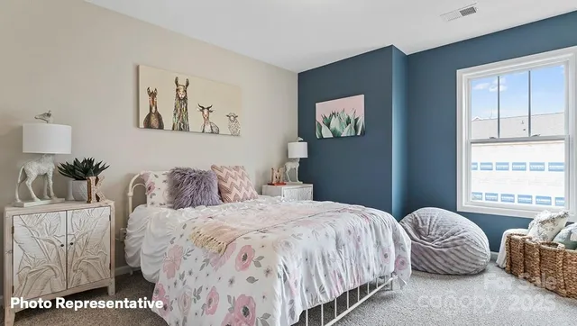 a bedroom with a bed and a couch