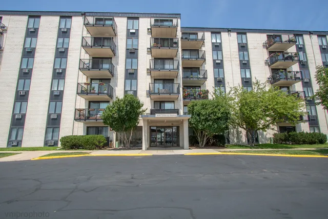 a front view of a building with a garden