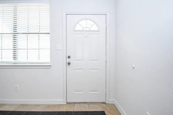 a view of front door with wooden floor