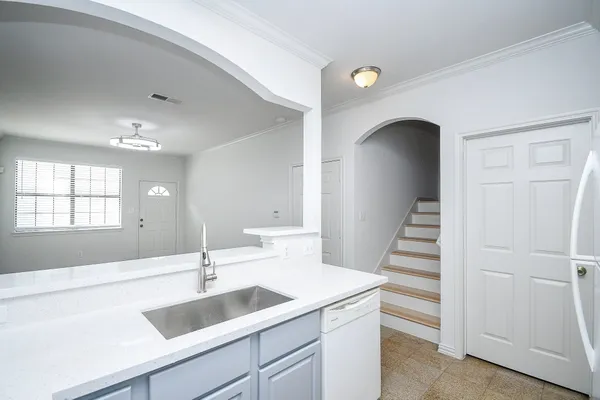 a view of a kitchen with a sink and dishwasher