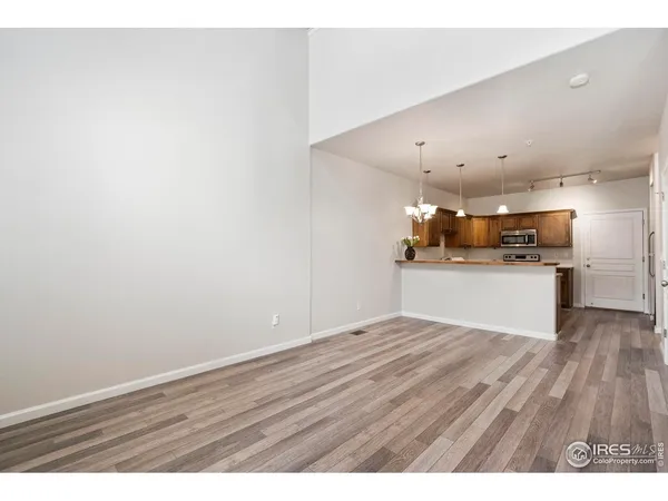 a view of a kitchen with a sink and a refrigerator