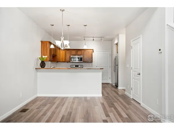 a view of a kitchen with a sink wooden floor and cabinets