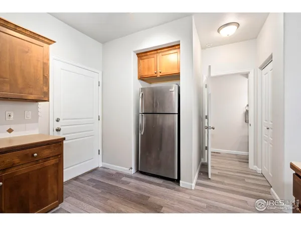 a kitchen with a refrigerator and cabinets