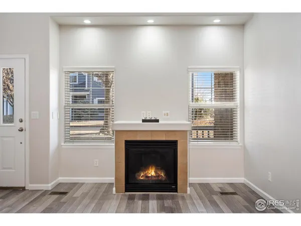 a living room with a fireplace and a window