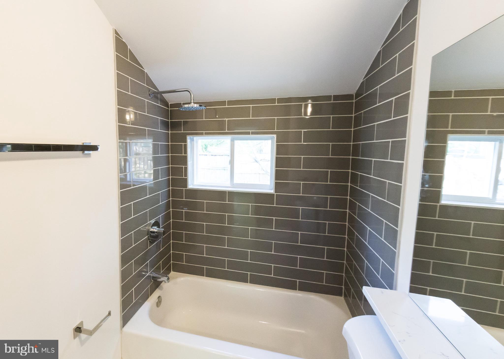 5151 Sheriff Road Northeast Washington, DC 20019 - Photo 12 of 20 a bathroom with a bathtub and shower