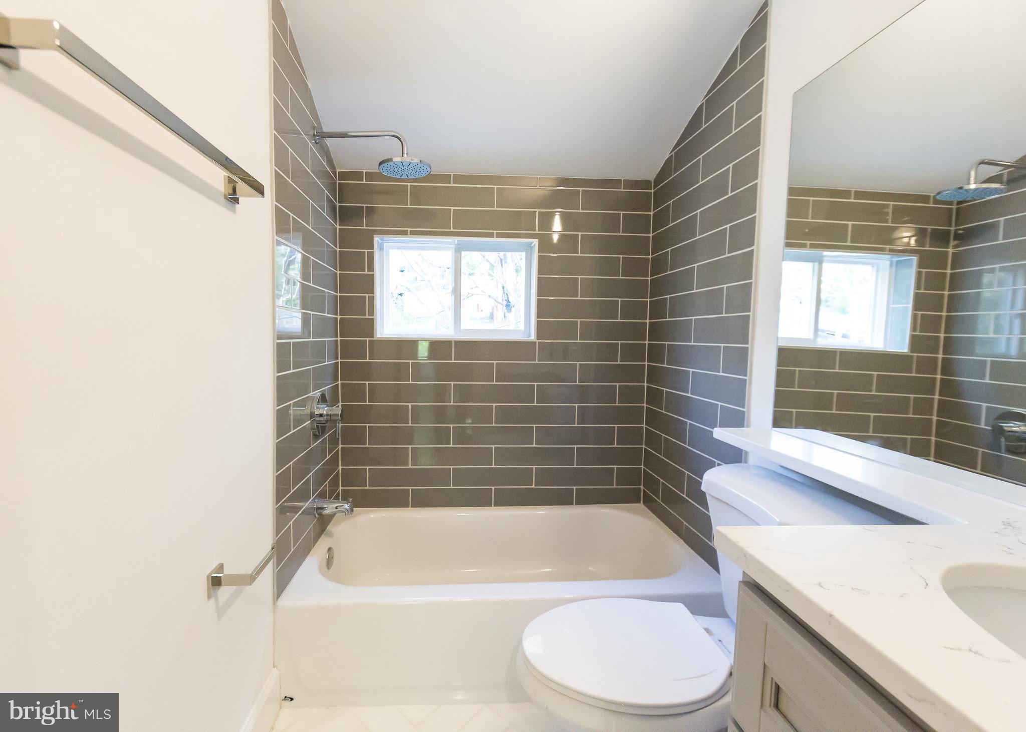 5151 Sheriff Road Northeast Washington, DC 20019 - Photo 13 of 20 a bathroom with a sink a toilet and bathtub