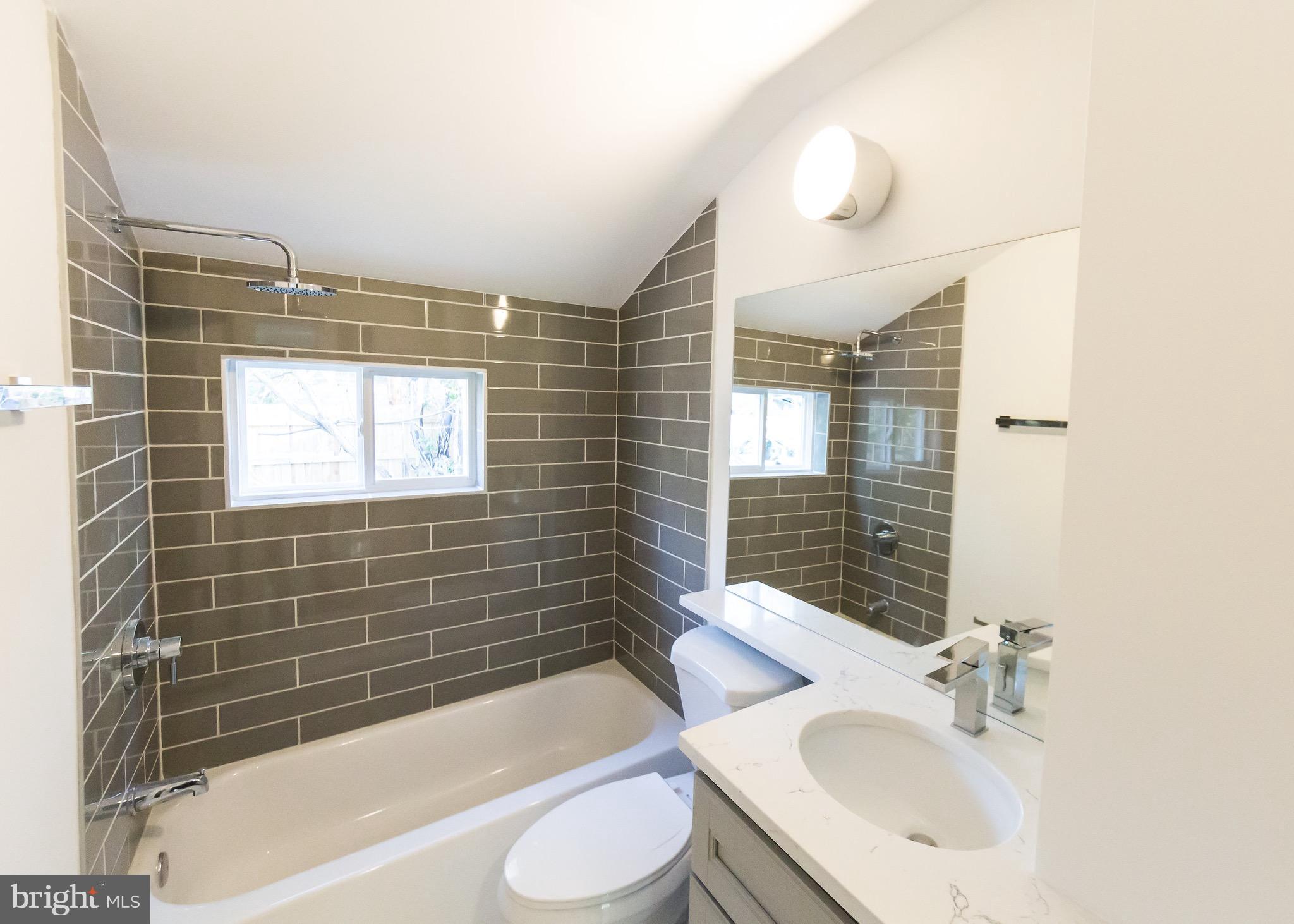 5151 Sheriff Road Northeast Washington, DC 20019 - Photo 14 of 20 a bathroom with a sink toilet tub and shower