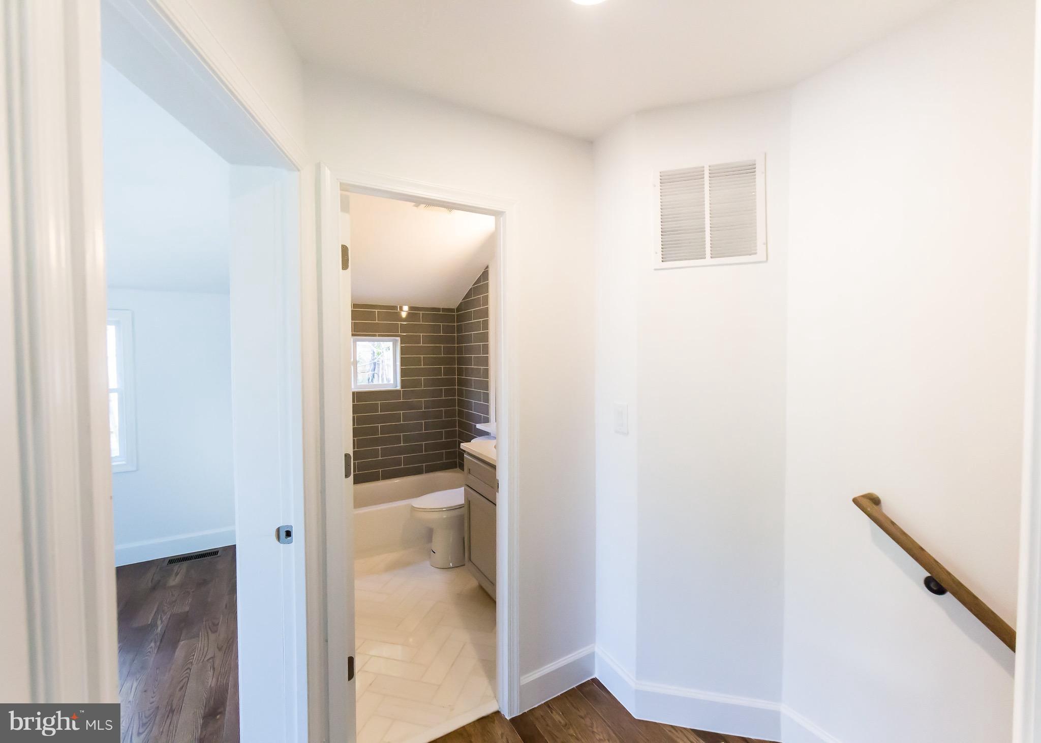 5151 Sheriff Road Northeast Washington, DC 20019 - Photo 17 of 20 a bathroom with a glass shower door and a sink