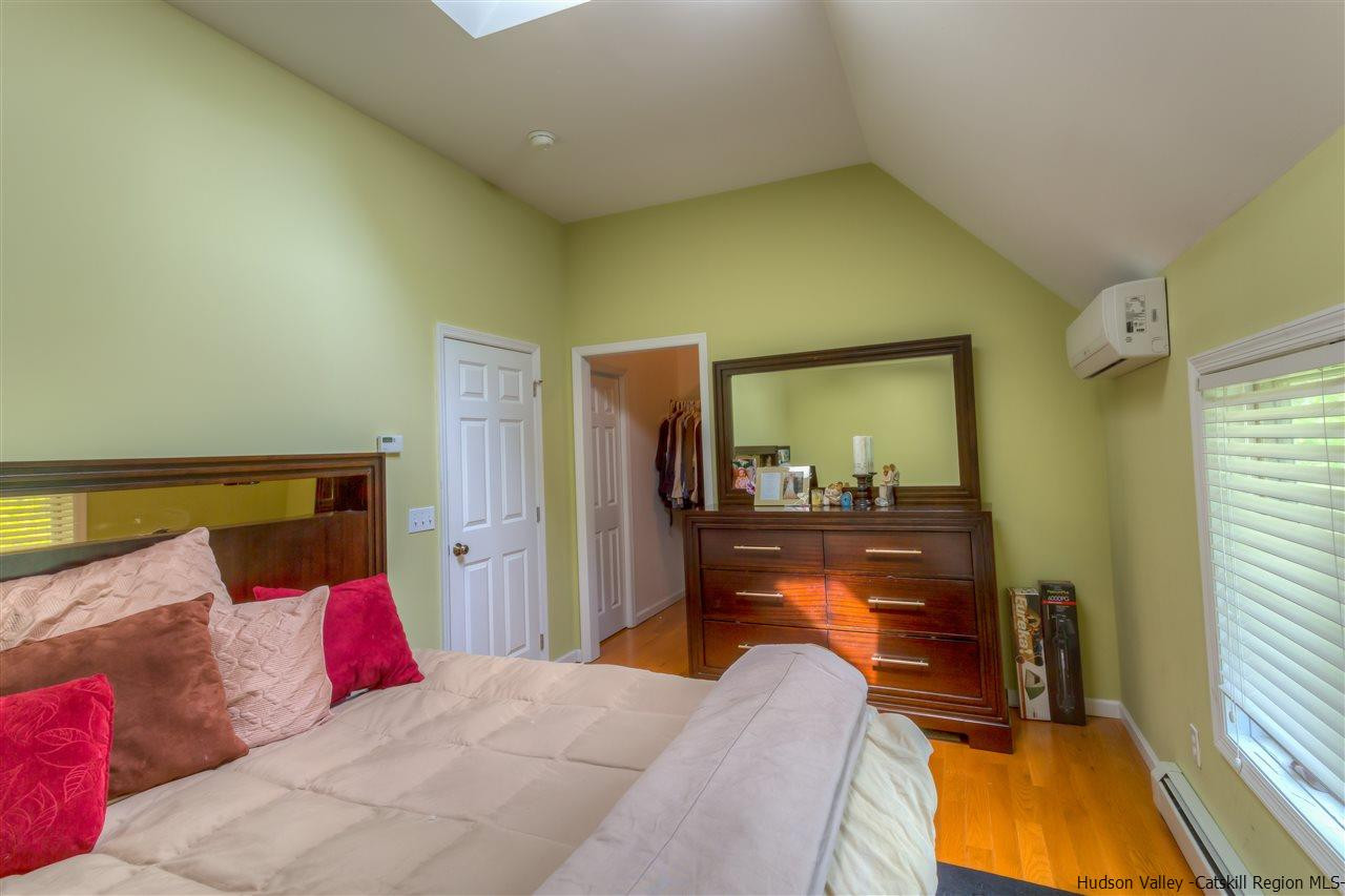 226 Rickey Road Stone Ridge, NY 12484 - Photo 13 of 17 a bedroom with a bed and a lamp next to a window