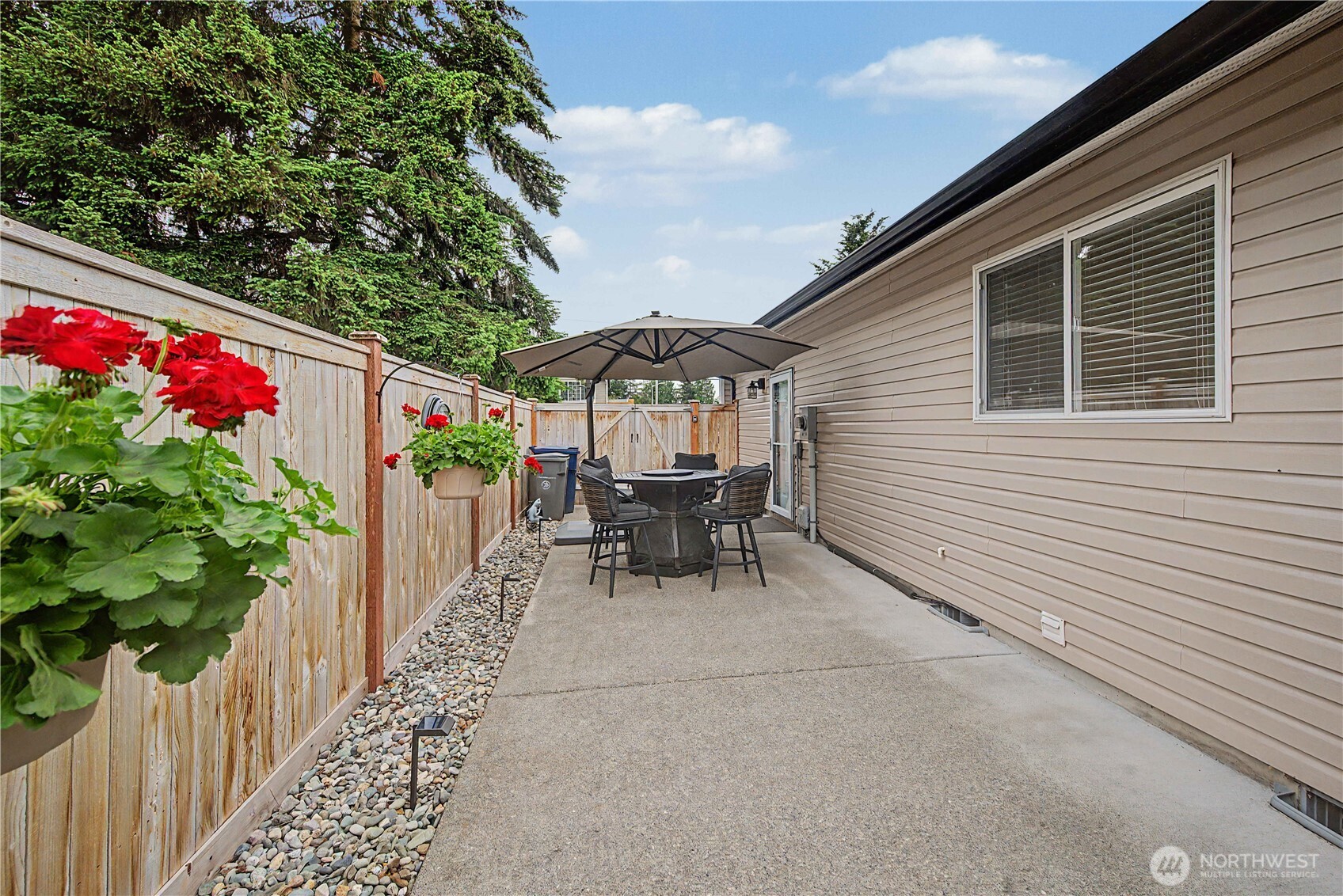 20919 Ronning Road Arlington, WA 98223 - Photo 23 of 28 a balcony with couple of chairs and a potted plant