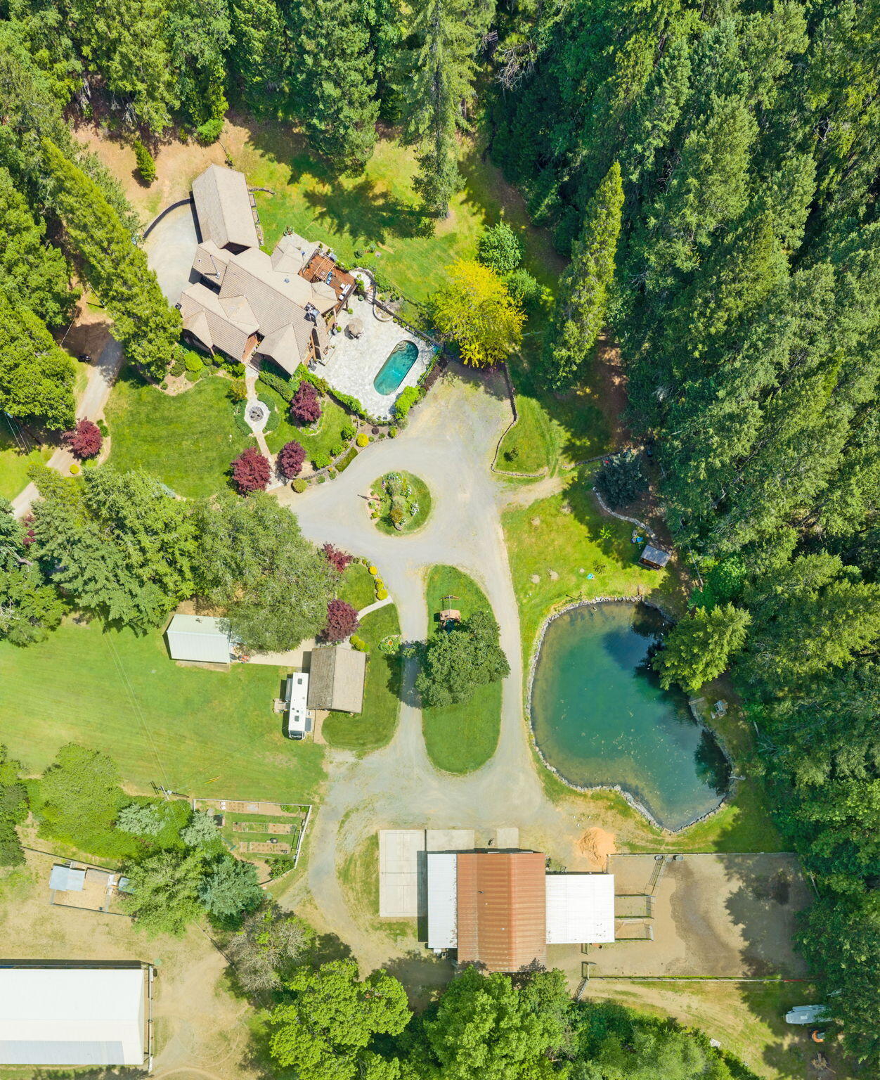 985 Elliott Creek Road Wilderville, OR 97543 - Photo 95 of 98 an aerial view of a house with swimming pool and large trees