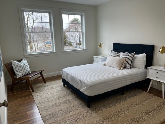 1 Pleasant Street, Unit 205 Cohasset, MA 02025 - Photo 20 of 24 a bedroom with a bed wooden floor and window