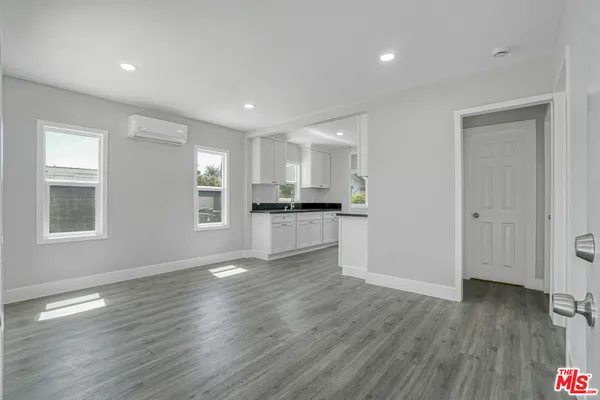 a view of kitchen with refrigerator and window
