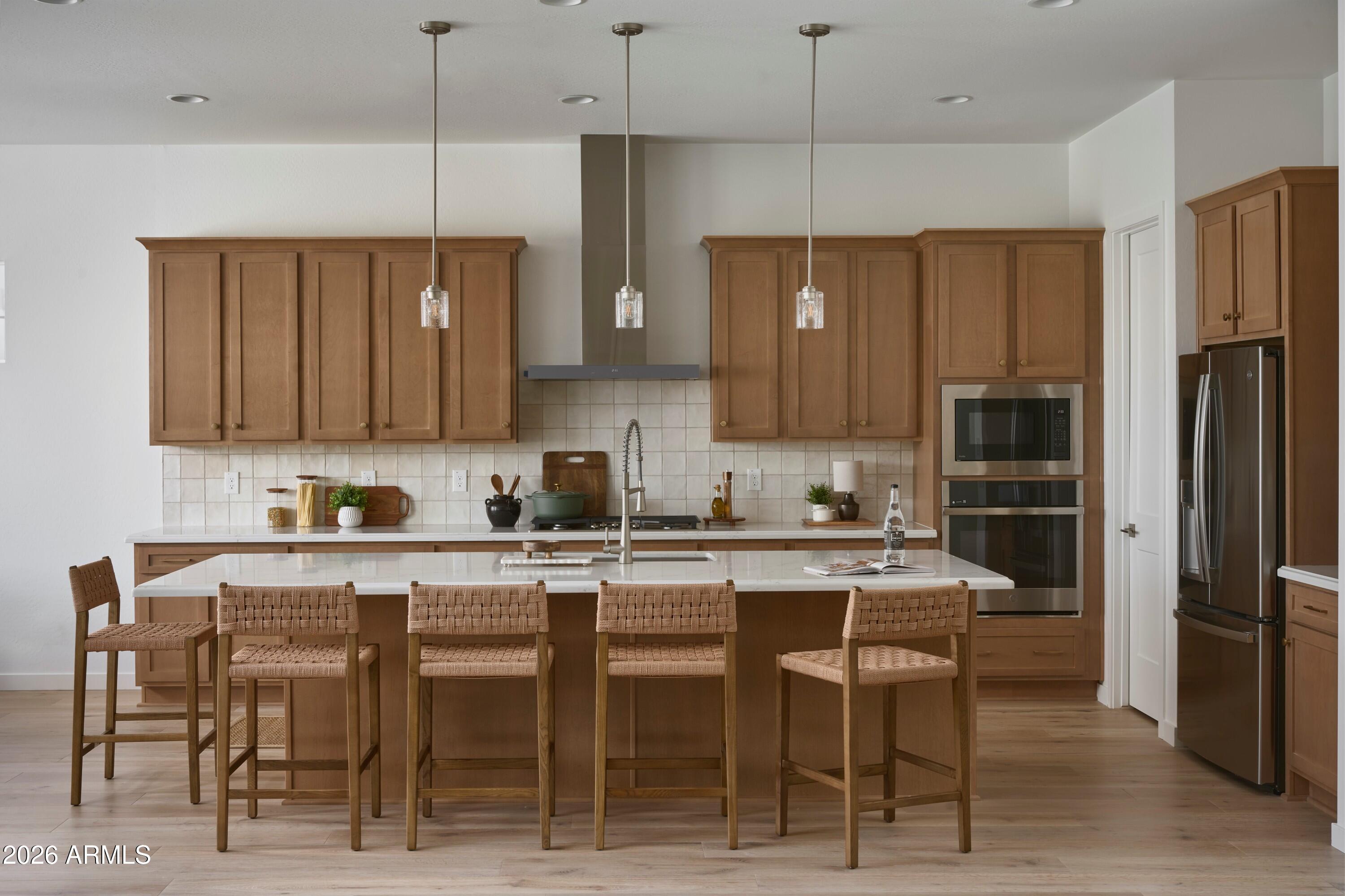 3705 East Constance Way Phoenix, AZ 85042 - Photo 2 of 10 a kitchen with granite countertop a table chairs refrigerator and microwave