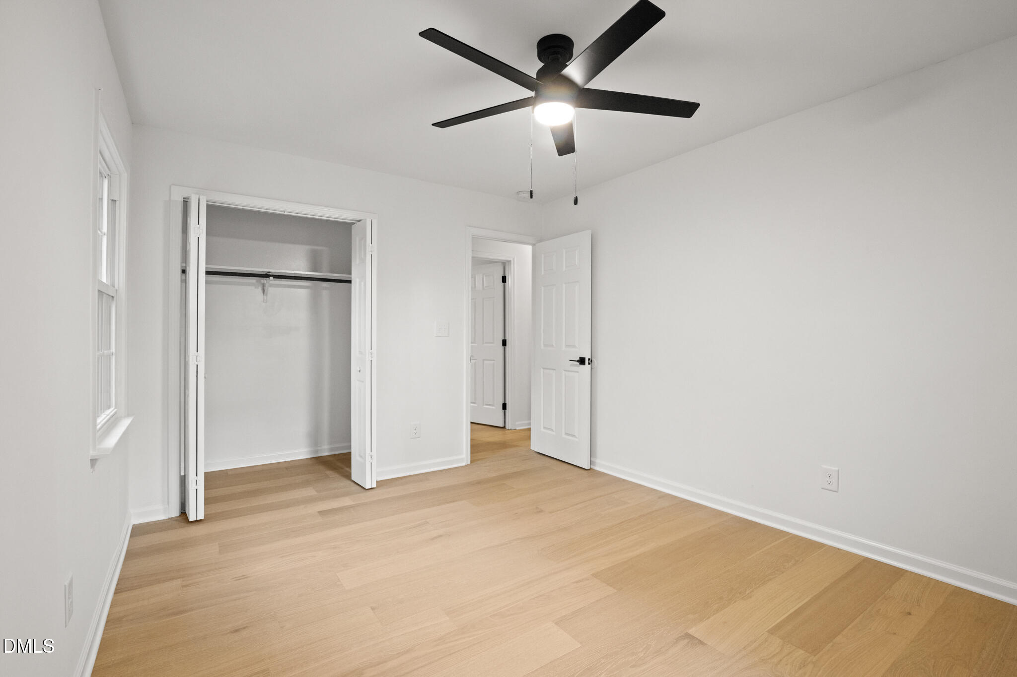 3509 Morningside Drive Raleigh, NC 27607 - Photo 34 of 49 an empty room with closet and a chandelier fan