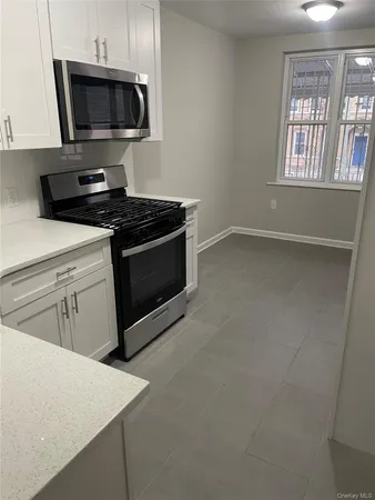 a kitchen with stainless steel appliances a sink dishwasher a stove and a microwave oven